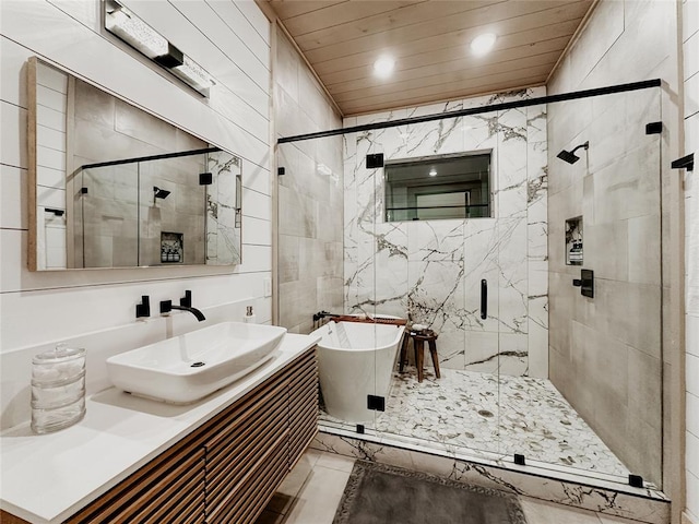 bathroom with shower with separate bathtub, vanity, and tile walls