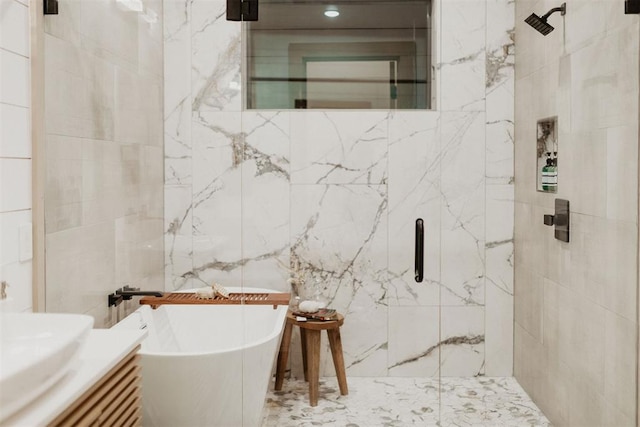 bathroom featuring vanity, tile walls, and independent shower and bath