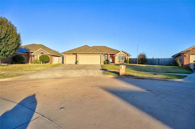 ranch-style house featuring a garage and a front lawn