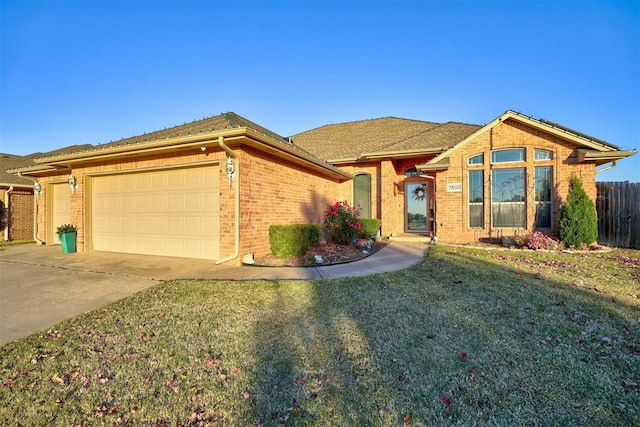 single story home with a garage and a front lawn