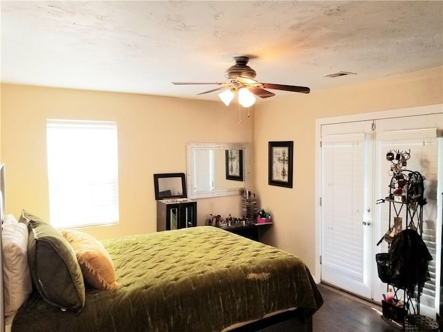 bedroom featuring ceiling fan and dark wood-type flooring