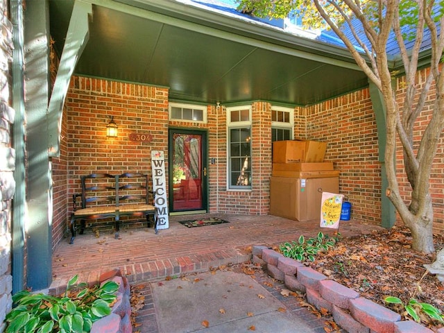 view of exterior entry with covered porch