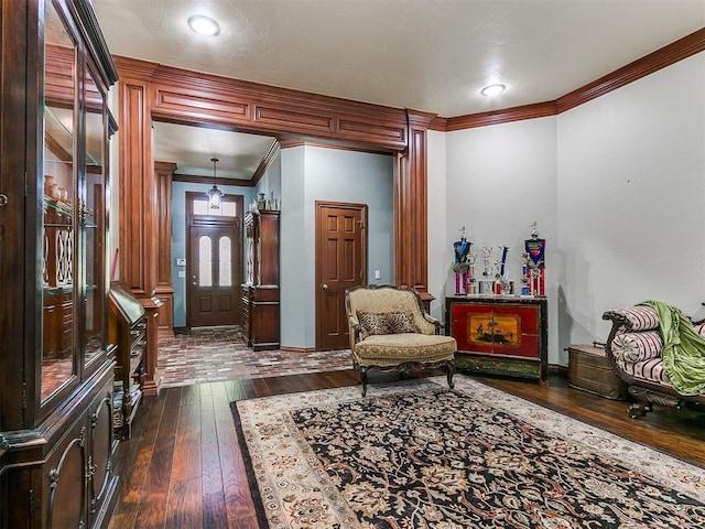 sitting room with crown molding and dark hardwood / wood-style flooring