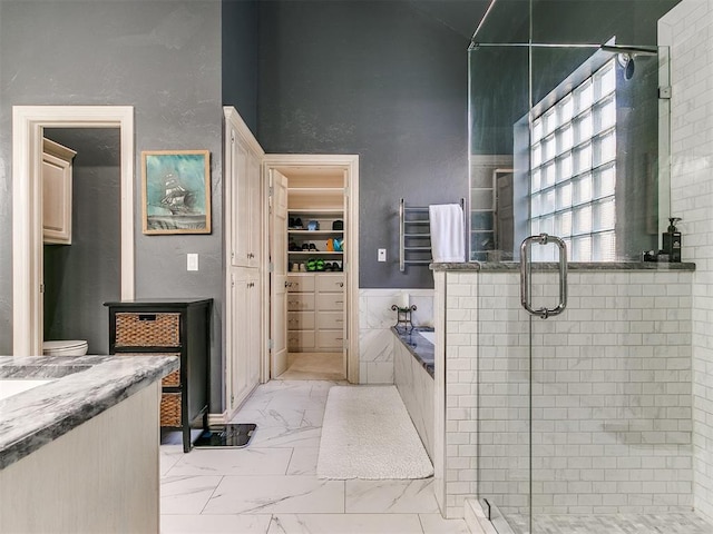 bathroom featuring vanity, tile walls, and plus walk in shower