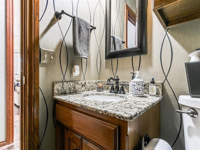 bathroom with vanity and toilet