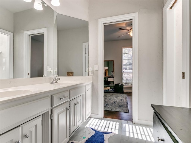 bathroom featuring ceiling fan, hardwood / wood-style floors, and vanity