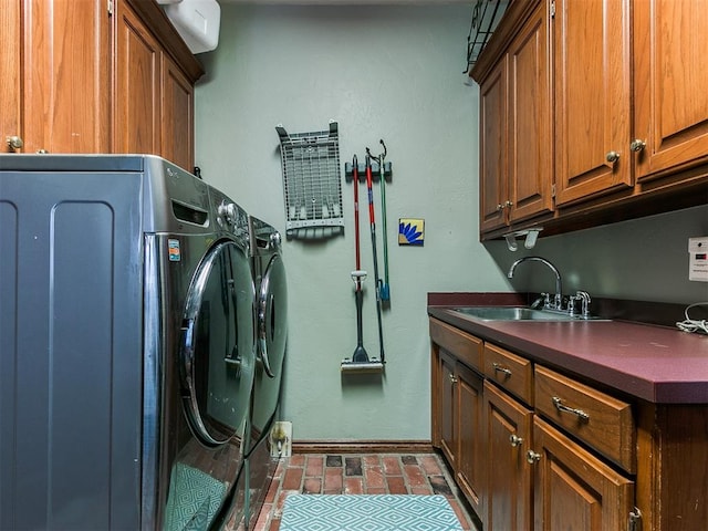 laundry area with cabinets, independent washer and dryer, and sink