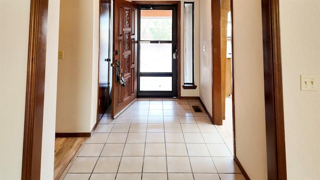 doorway to outside with light tile patterned floors