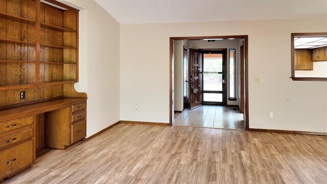 interior space featuring built in desk and light hardwood / wood-style floors