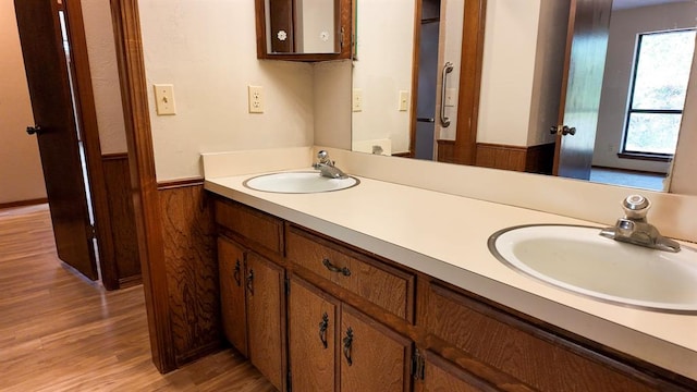 bathroom featuring wood-type flooring, vanity, and wood walls