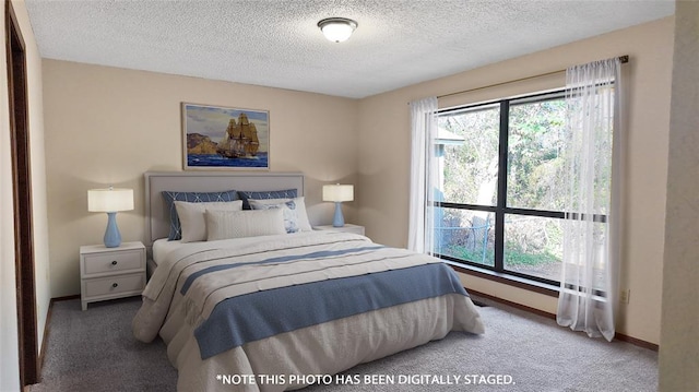 bedroom with carpet floors, multiple windows, and a textured ceiling