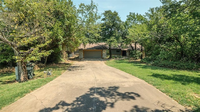 view of front of property with a garage and a front yard