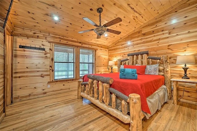 bedroom with ceiling fan, light hardwood / wood-style flooring, wood walls, vaulted ceiling, and wood ceiling