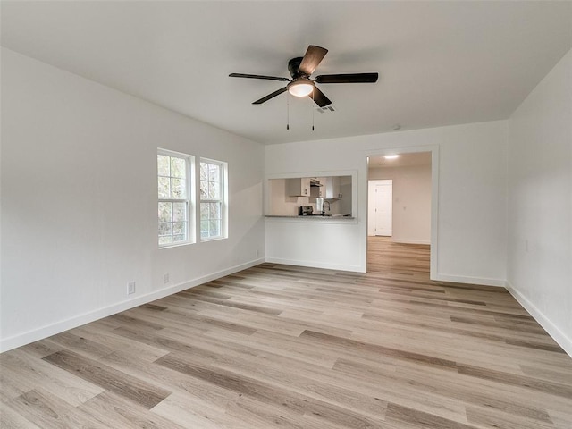 unfurnished living room featuring light wood-type flooring and ceiling fan