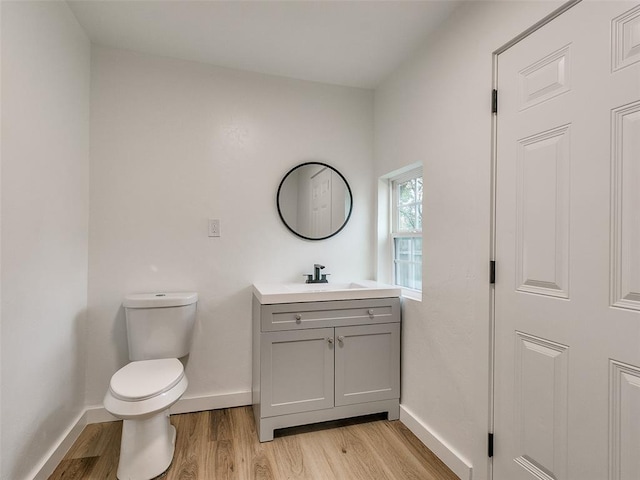 bathroom featuring hardwood / wood-style flooring, vanity, and toilet