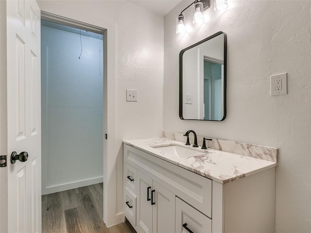 bathroom with hardwood / wood-style floors and vanity