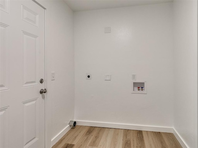 clothes washing area with electric dryer hookup, hookup for a washing machine, and light hardwood / wood-style flooring