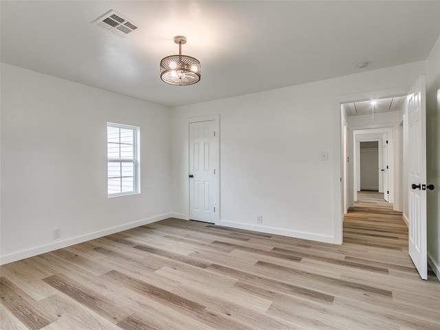 unfurnished room with light wood-type flooring