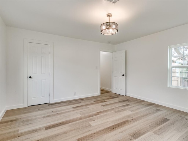 unfurnished room featuring light hardwood / wood-style floors