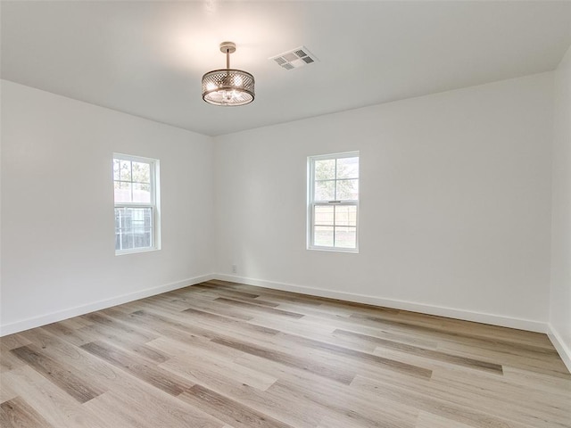 empty room with light wood-type flooring and a healthy amount of sunlight