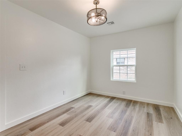 spare room featuring light wood-type flooring