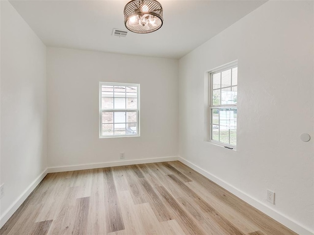 empty room with plenty of natural light and light wood-type flooring