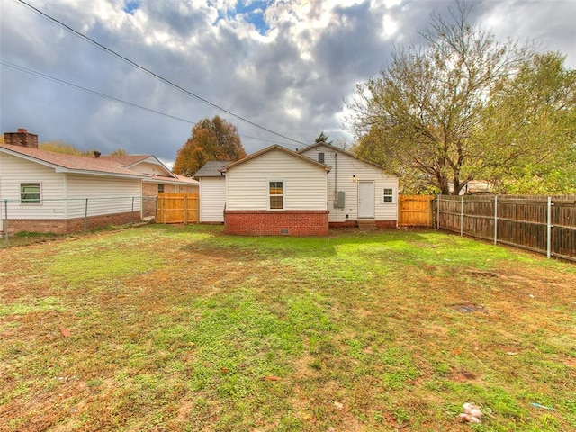 rear view of property featuring a yard