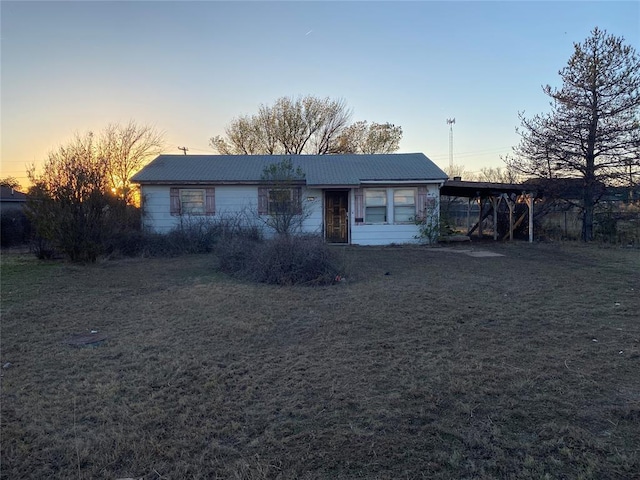 single story home with a carport and a lawn