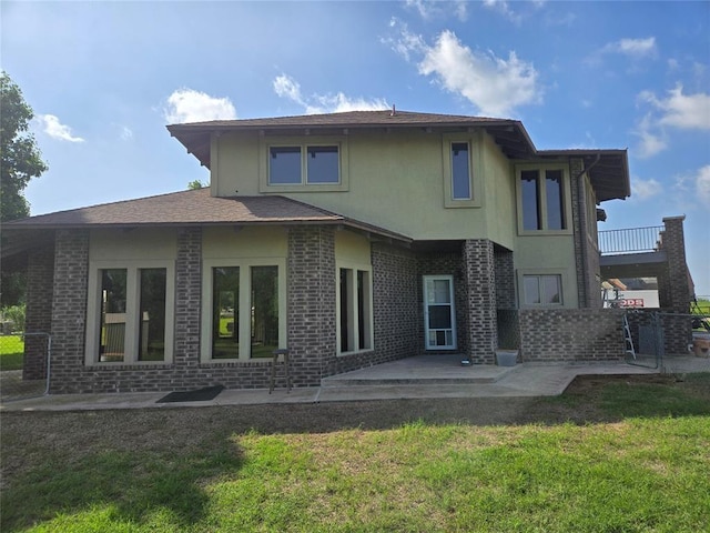 back of house with a lawn and a patio area