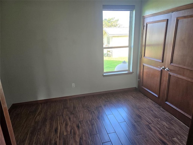 empty room with dark wood-type flooring