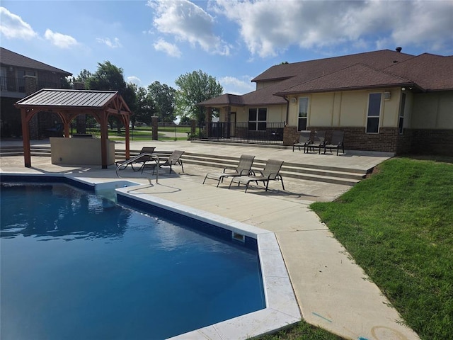 view of swimming pool with a gazebo and a patio area