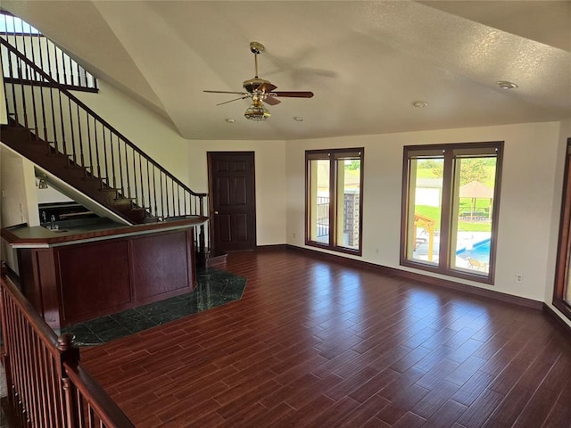 foyer featuring a textured ceiling, ceiling fan, dark hardwood / wood-style flooring, and lofted ceiling