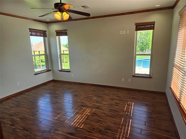 empty room featuring dark hardwood / wood-style floors, a healthy amount of sunlight, and ornamental molding