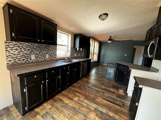 kitchen featuring a textured ceiling, dark hardwood / wood-style flooring, ceiling fan, and sink