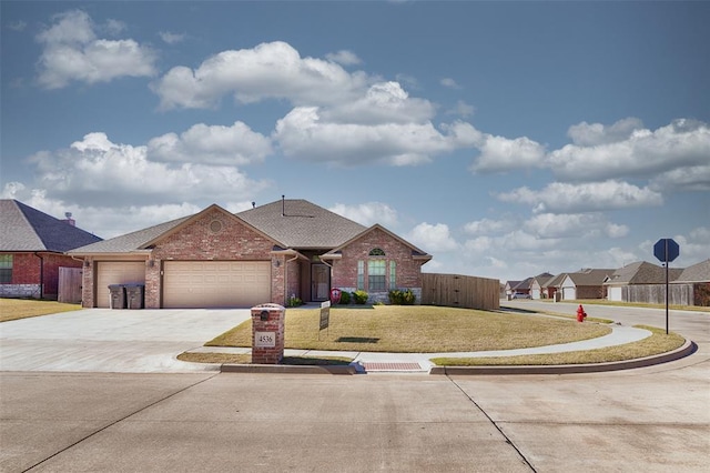 4536 Oasis Ct, Yukon, OK 73099 - view of front of house featuring brick siding, an attached garage, driveway, and roof with shingles