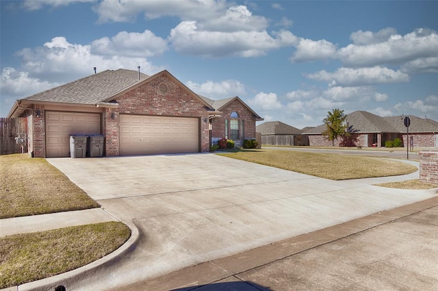 ranch-style house featuring a front lawn and a garage