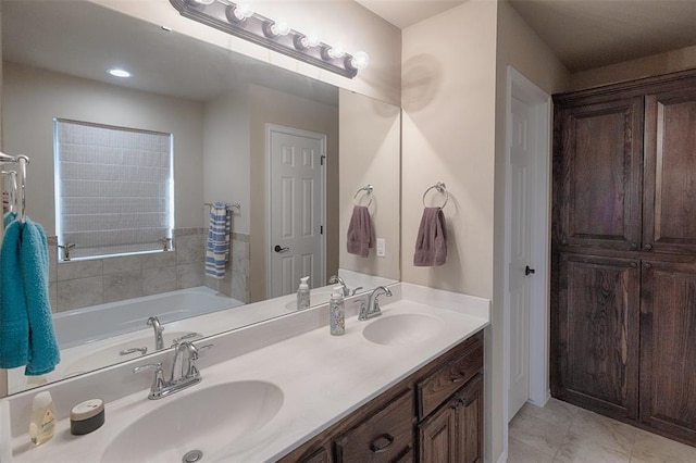 bathroom featuring a washtub and vanity