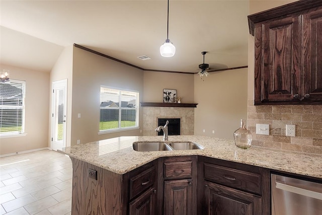 4536 Oasis Ct, Yukon, OK 73099 - kitchen with a sink, dishwasher, a peninsula, dark brown cabinetry, and plenty of natural light