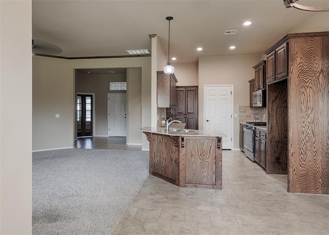 4536 Oasis Ct, Yukon, OK 73099 - kitchen featuring appliances with stainless steel finishes, a peninsula, decorative backsplash, dark brown cabinets, and a kitchen breakfast bar