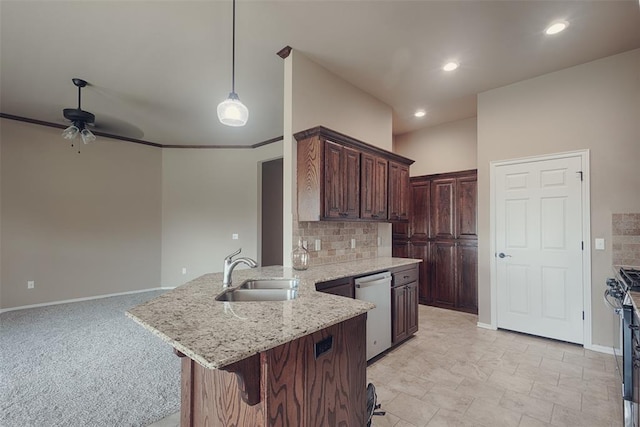 4536 Oasis Ct, Yukon, OK 73099 - kitchen featuring a sink, appliances with stainless steel finishes, a peninsula, ceiling fan, and backsplash