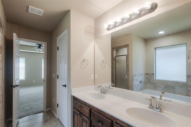 4536 Oasis Ct, Yukon, OK 73099 - bathroom featuring tile patterned flooring, a garden tub, ceiling fan, double vanity, and a stall shower