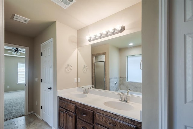 4536 Oasis Ct, Yukon, OK 73099 - bathroom featuring tile patterned flooring, double vanity, a garden tub, and healthy amount of natural light