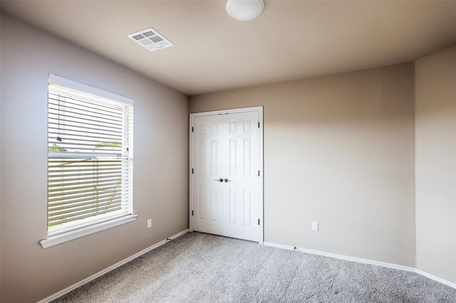 4536 Oasis Ct, Yukon, OK 73099 - unfurnished bedroom featuring light carpet, baseboards, and a closet