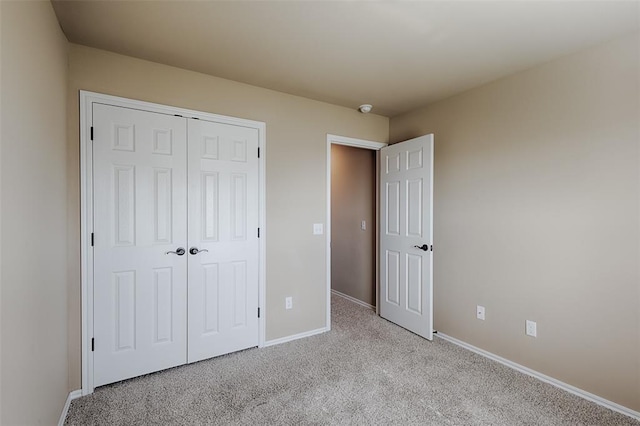 4536 Oasis Ct, Yukon, OK 73099 - unfurnished bedroom with light colored carpet, baseboards, and a closet