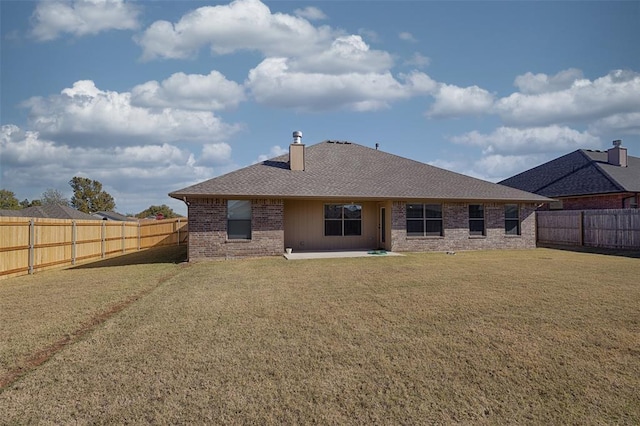 4536 Oasis Ct, Yukon, OK 73099 - rear view of house with brick siding, a patio area, a chimney, and roof with shingles