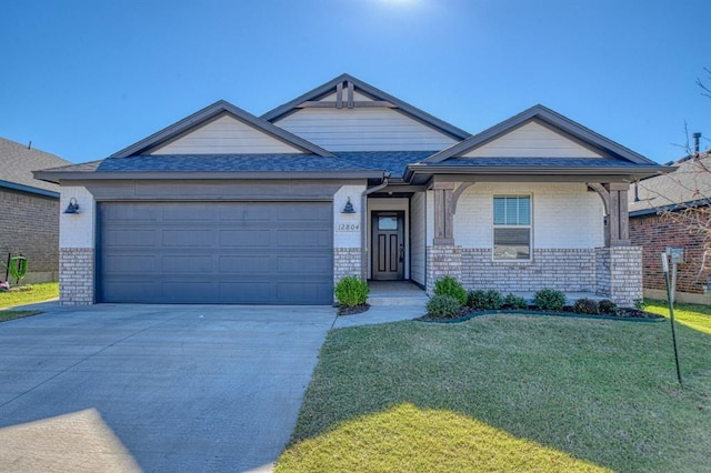 view of front of house featuring a front lawn and a garage