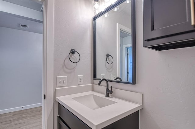 bathroom featuring hardwood / wood-style flooring and vanity