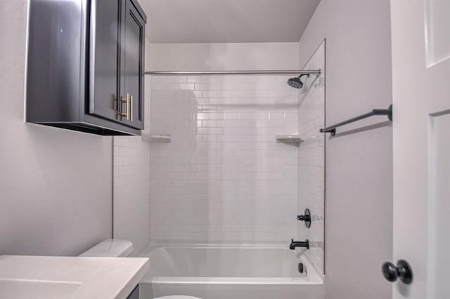 full bathroom featuring vanity, toilet, and tiled shower / bath