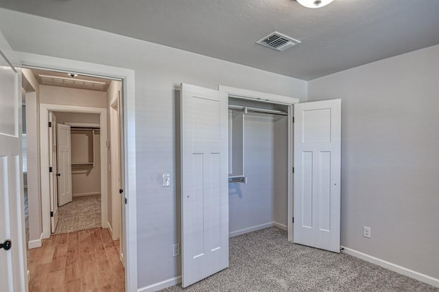 unfurnished bedroom featuring a closet and hardwood / wood-style flooring