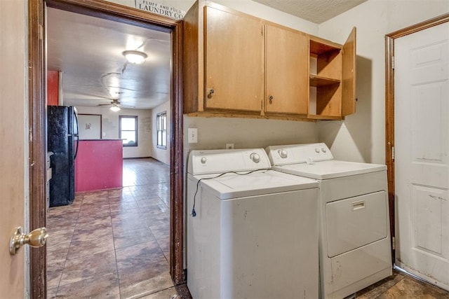 laundry area with cabinets, washing machine and dryer, and ceiling fan